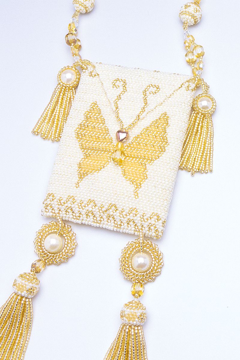 detail of white butterfly beaded amulet bag