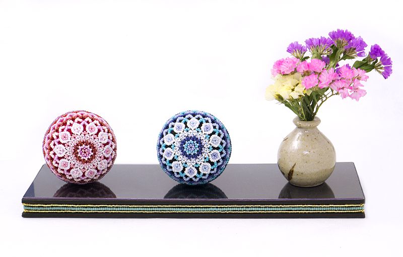 Dewdrop Beaded Temari displayed with flower arrangement