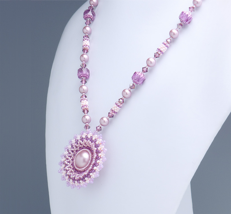 Circular Flowery Pendant Necklace: closeup of the rose pink necklace