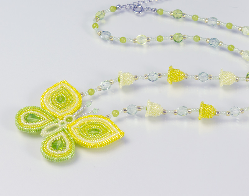 Butterfly and Bell-Shaped Flowers Necklace: closeup of the yellow necklace