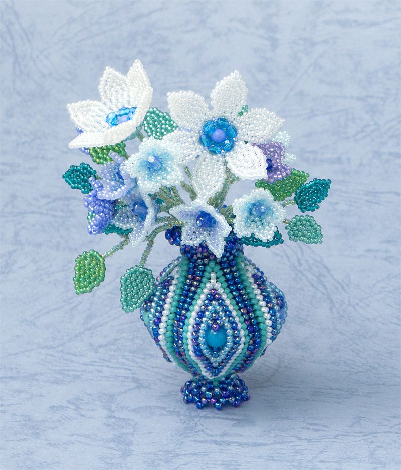 Dark Blue striped vase with a bunch of white and blue flowers